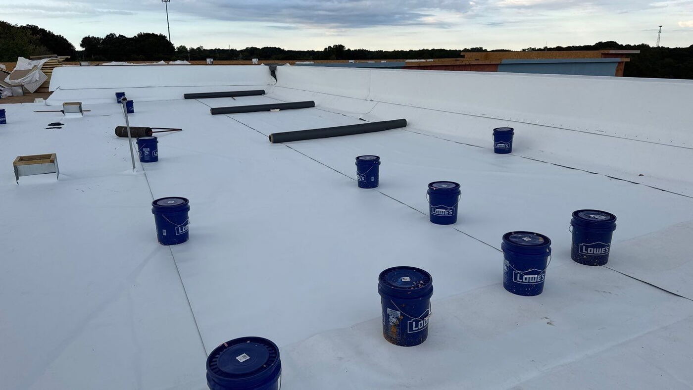 Commercial roofing crew working on a facility roof